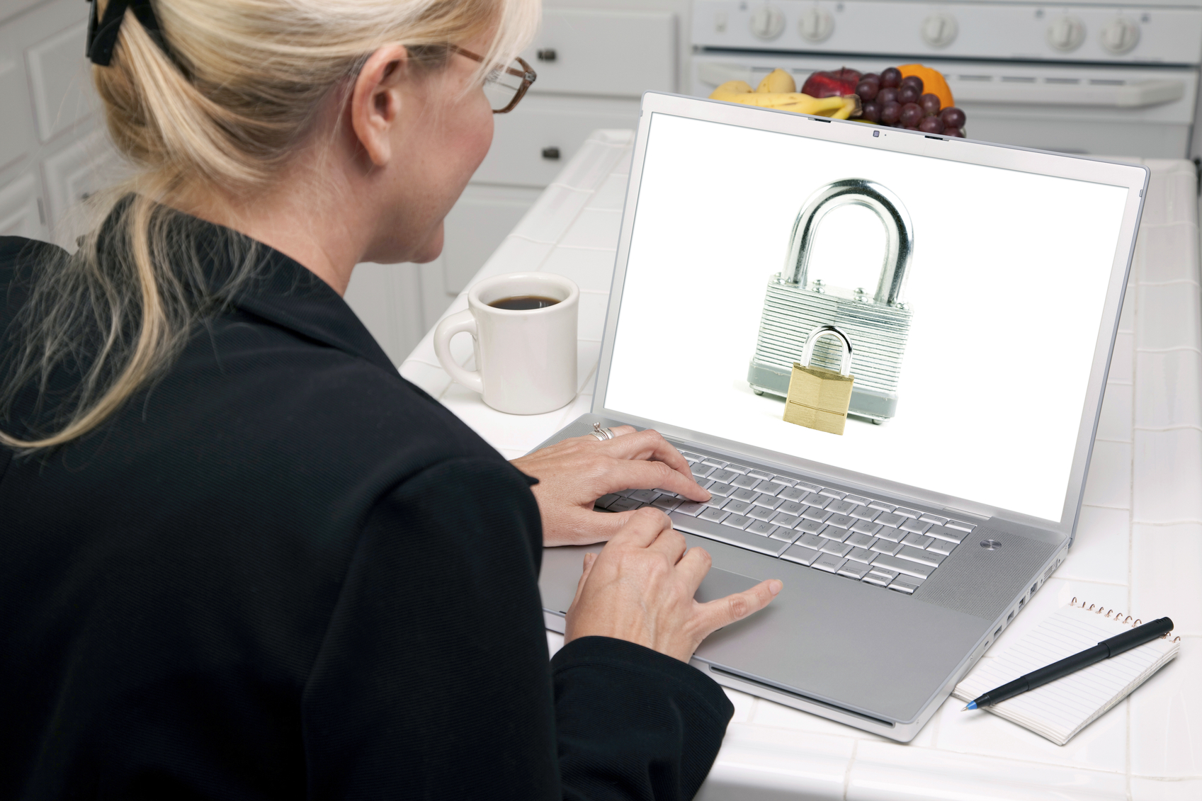 Woman In Kitchen Using Laptop - Security